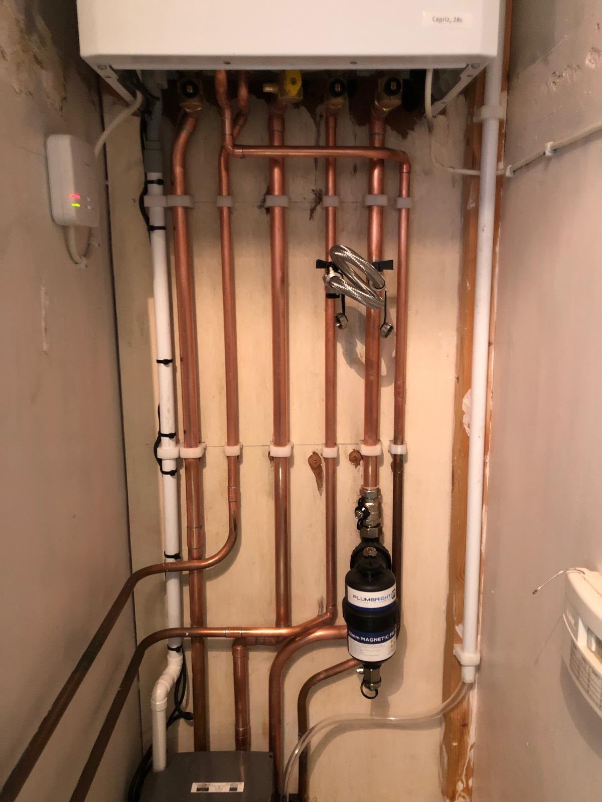 Wall mounted combi boiler with precise copper pipework and a Plumbright magnetic filter