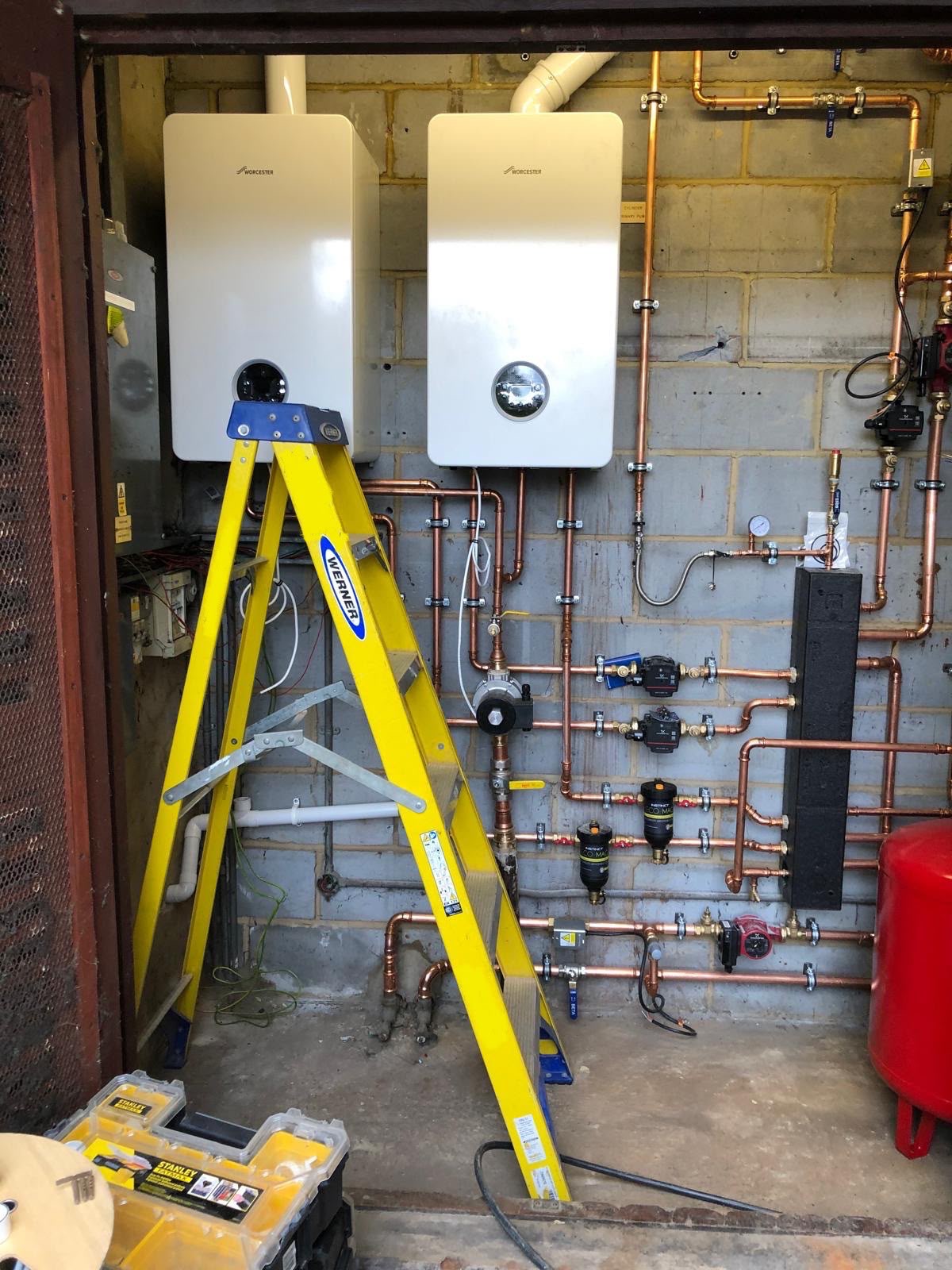 Twin Worcester Bosch boilers installed side by side with pumps, magnetic filters and a low loss header
